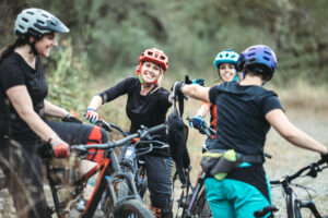 A group of friends has fun riding beautiful mountain bike paths and trails in the Pacific Northwest.  Horizontal image with copy space.